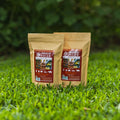 Two packages of 'Smokin' Pecan' pecan shell pellets on grass