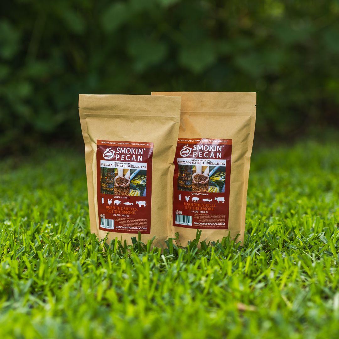 Two packages of 'Smokin' Pecan' pecan shell pellets on grass
