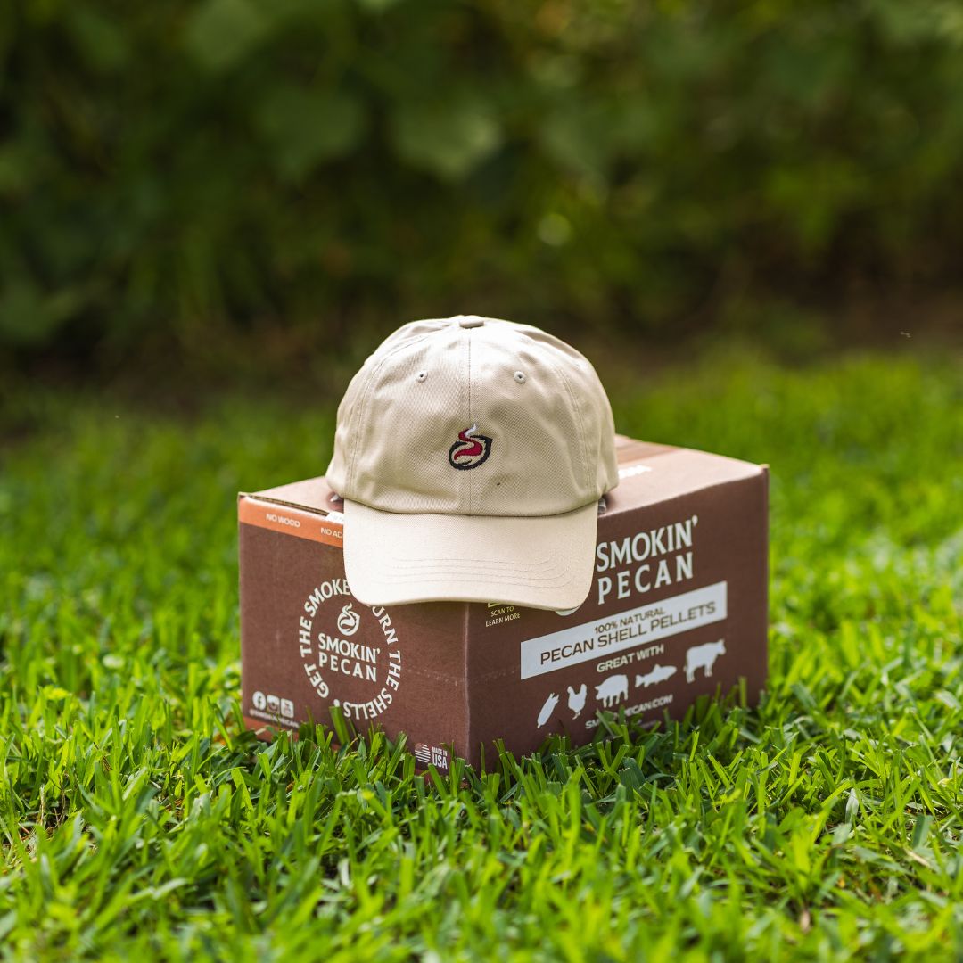 Beige cap on a box of Smokin' Pecan Pellets in grass